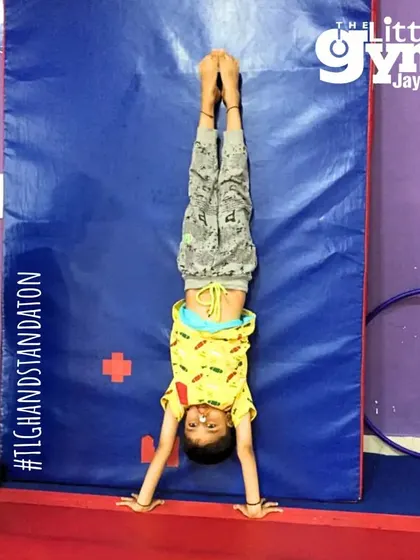 A perfect wall handstand! This exercise is a fantastic way to build the shoulder and core strength needed for freestanding handstands.