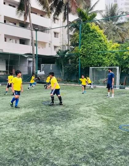 Players engaged in a warm-up activity. Every session begins with exercises to prepare them physically and mentally.