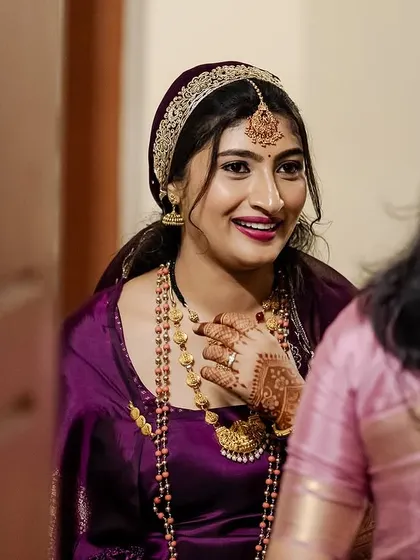 A candid moment of the bride. Her makeup looks flawless, and her smile is genuine and beautiful.