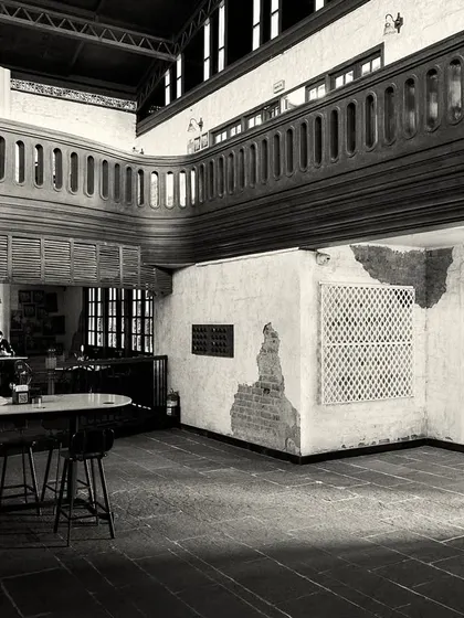 A wide view of the ground floor, showing how different seating areas are zoned using furniture and low railings.