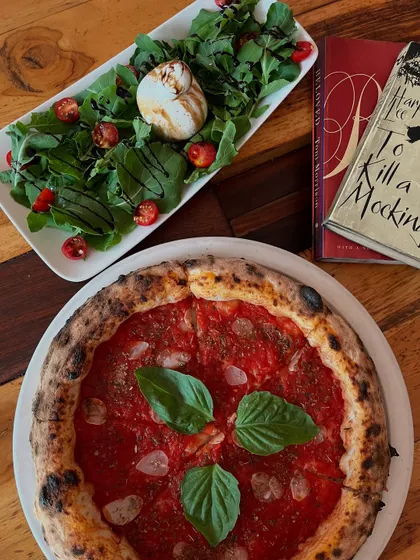 A beautiful spread: Marinara pizza, Burrata salad, and a good book. The perfect afternoon.