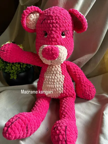 Here is our take on the classic Pink Panther. We used a vibrant pink chunky yarn to create this lanky, cool cat. It's a larger plushie, perfect for big hugs and adding a fun, retro vibe to any room.