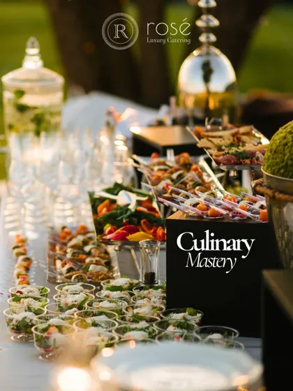 A beautifully arranged appetizer station with a sign that reads "Culinary Mastery." This reflects our team's dedication to crafting masterpieces from the freshest, most exquisite ingredients.