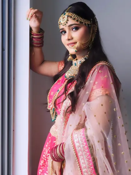 This pose highlights the beautiful dupatta draping and makeup, skills that are essential for any professional bridal artist.