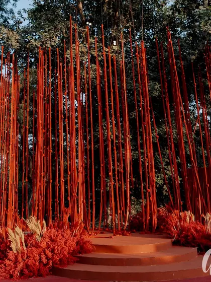 A striking photo backdrop created with hundreds of vertical red-wrapped batons. This installation provided a powerful, textured visual that was both modern and dramatic, perfect for guest photos.