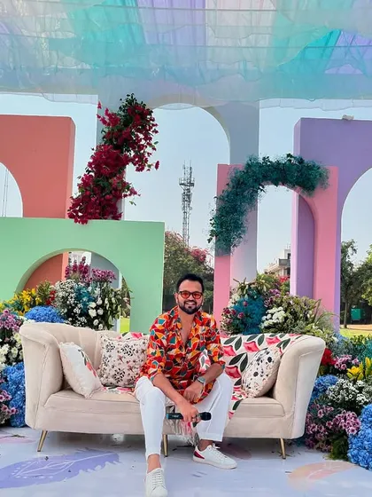 Taking a moment to soak in the vibrant, colorful decor of a daytime carnival. The beautiful setup is the perfect backdrop for a day of fun.