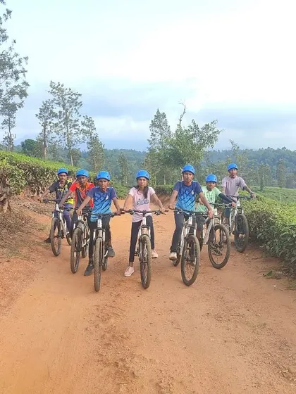 A team of young girls on mountain bikes ready to explore the dirt tracks and scenic routes of Barapole.