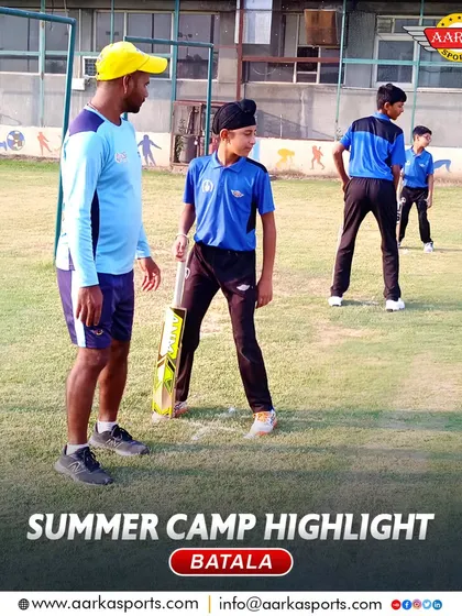 A coach gives instructions to a young batsman during the summer camp. Our coaching is hands-on and supportive.