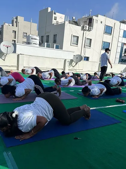 Students practicing Ashtanga Namaskara (Eight-Limbed Pose), a key part of the Surya Namaskar sequence, demonstrating strength and coordination.