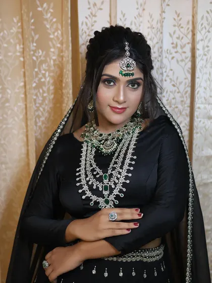 A confident portrait of the model in the stunning green and silver-toned set.
