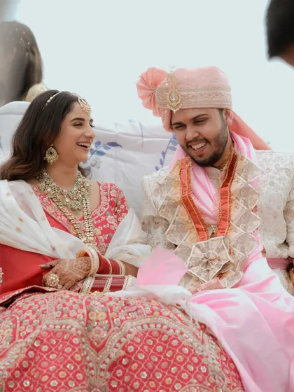 Laughter and joy as the couple shares a lighthearted moment during their wedding rituals.