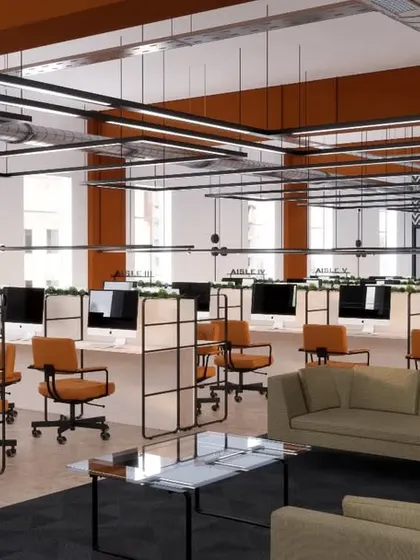 An overview of the open desk area at KCC Works. The layout is designed for flexibility, with a mix of dedicated workstations and hot-desking areas separated by low partitions.