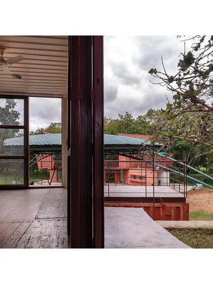 A view from inside one of the repurposed shipping containers at Earth Alive. The design opens up these industrial boxes, creating airy, light-filled spaces that connect with the surrounding re-wilded landscape.