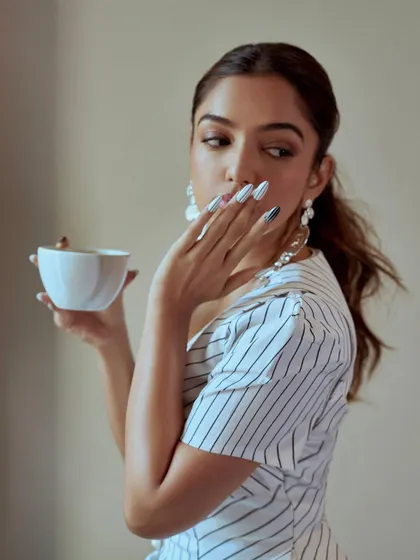 A different vibe with these black and white striped press-on nails. This look is more graphic and playful, showing the range of styles we can create for any occasion.