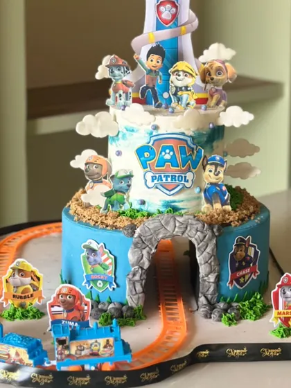 This pup-tastic Paw Patrol cake is ready to roll into the paw-ty. Featuring the iconic lookout tower and a working toy train track, it's a cake that's as fun to play with as it is to eat.