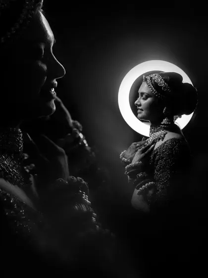 A creative black and white portrait using a ring light to create a stunning halo effect.