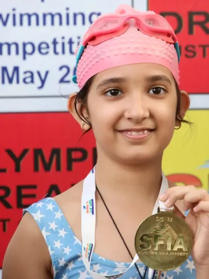 The smile of a champion. This young swimmer proudly displays her Gold medal after a great performance at our Future Champions meet.