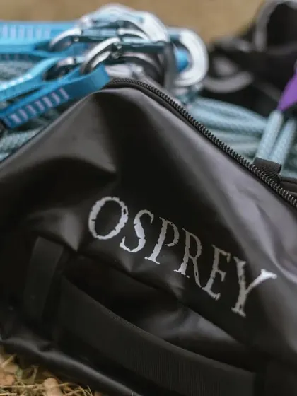 A close-up of our gear, including an Osprey bag, ropes, and helmets. We partner with top brands to provide reliable and high-quality equipment.