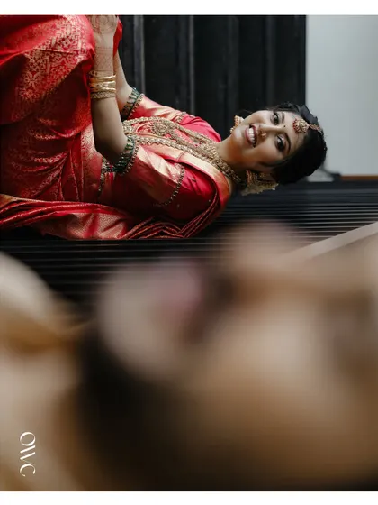 A creative, low-angle shot of the bride, with a blurred foreground creating an artistic effect.