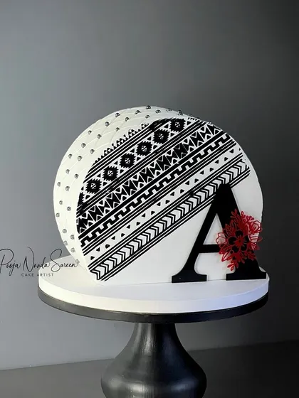Another view of the striking top-forward cake featuring our custom acrylic initial. It adds a strong, personalized element to the design.