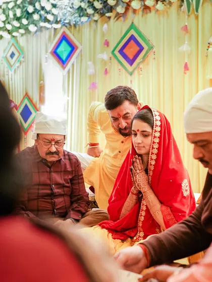 A moment of prayer and reflection during the pre-wedding puja. We respectfully capture these quiet, spiritual moments that are a core part of the wedding journey.