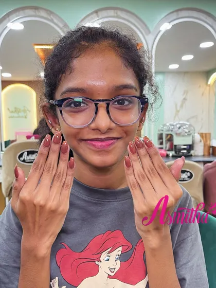 Another shot of our happy student client, smiling with her perfectly finished nail extensions. Her confidence is our greatest reward.