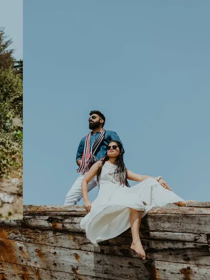 A stylish shot of a couple posing on an old wooden boat in Alibag, exuding confidence and modern style.