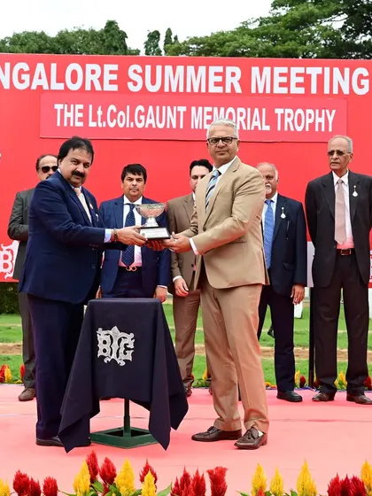 Mr. K. Harish Nayak, Committee Member, presents The Lt.Col. Gaunt Memorial Trophy to the owners of Don Carlos.
