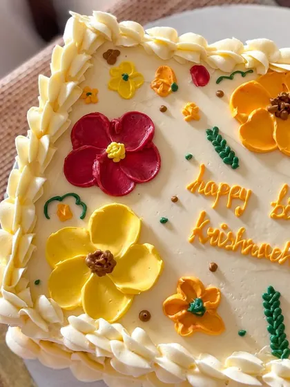 A close-up of the hand-piped buttercream flowers in warm, retro colors.