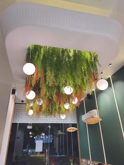 A close-up of the hanging foliage ceiling feature, showcasing the mix of colors and textures that create a vibrant, cascading effect.