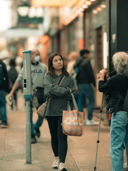 A candid moment of a woman observing the busy streets of Hong Kong. I'm always looking for people who seem lost in thought, offering a glimpse into their inner world.