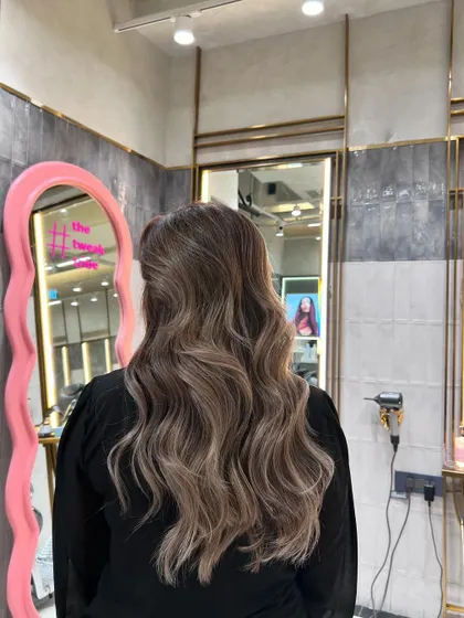 An ash blonde balayage that adds depth and dimension. This look is perfect for those seeking a natural yet striking style with a touch of cool elegance.