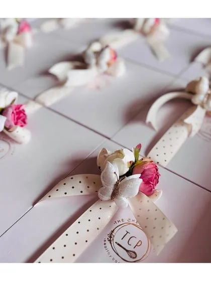 A close-up of the beautiful detailing on our baby announcement boxes. The combination of the butterfly, flowers, and ribbon makes for a truly special gift.