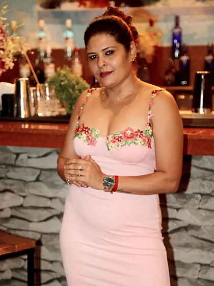 A custom-designed pink bodycon dress with floral embroidered straps, worn for an event at a restobar.
