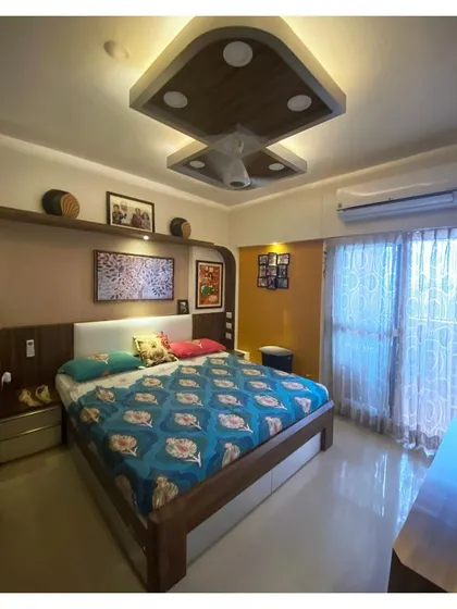 For the Malhotra Apartment, we designed a master bedroom that balances warm undertones with personal touches. The space features custom woodwork, integrated cove lighting in the ceiling, and an accent wall, creating a comfortable and timeless personal sanctuary that has remained stylish for over six years.