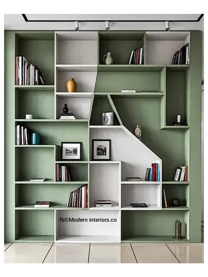 A stylish and functional shelving unit in a lovely sage green and white. The geometric design creates interesting nooks for both books and decor, adding personality to the wall.