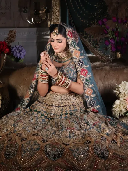 This pose captures the elegance of the bride, highlighting the detailed work on the dupatta and the flawless makeup.