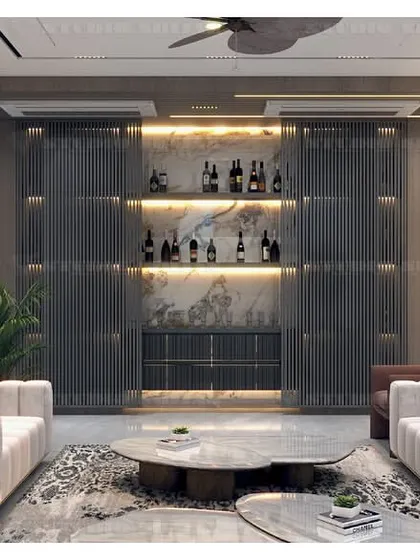 This view of the Kirti Nagar drawing room reveals a custom-designed bar area with fluted glass doors, seamlessly integrated into the living space.