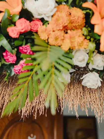 A decor detail featuring paddy stalks and colorful flowers.