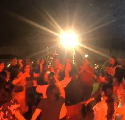 The party is lit with red lights, keeping the energy high.