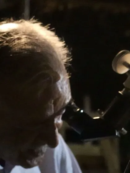 A guest smiles as she looks at the moon through our telescope.