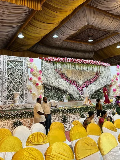 Another angle of the heart-shaped floral stage, showing the intricate white jaali panels on the sides. This combination of traditional patterns and lavish florals is a signature of my premium wedding decor.