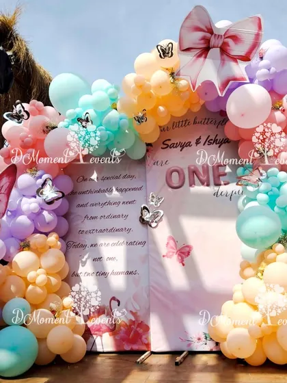 Another angle of the pastel butterfly backdrop, highlighting the large bow prop and the beautiful blend of colors in the balloon arrangement.