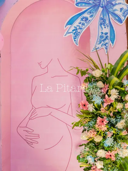 A minimalist and elegant backdrop with a line-art drawing of an expectant mother, part of the chic Baby Dior theme.