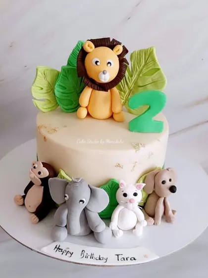 For baby Tara, a lovely cake with all her favorite jungle animals. I handcrafted the lion, elephant, monkey, cat, and dog to create a special birthday zoo.