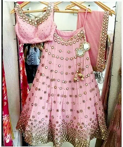 Mirror work lehengas are a festive favorite. I can stitch outfits with all-over mirror and thread work, ensuring each detail is perfectly placed for a stunning effect.