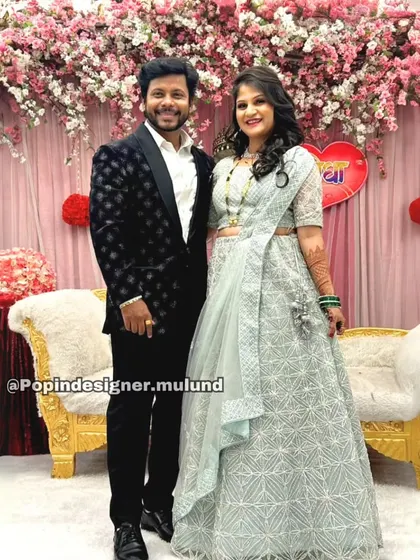 Another photo of the lovely couple. His black tuxedo provides a classic contrast to her embroidered lehenga, making them both stand out.