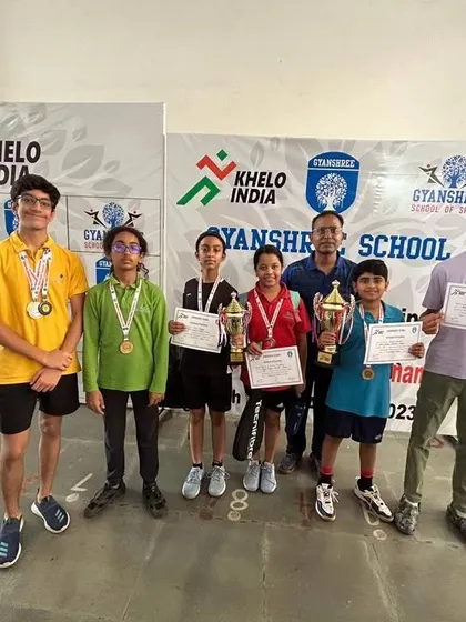 Proud winners of the Gyanshree School Squash Tournament with their medals, certificates, and trophies. We work to create opportunities for students to experience the thrill of competition.