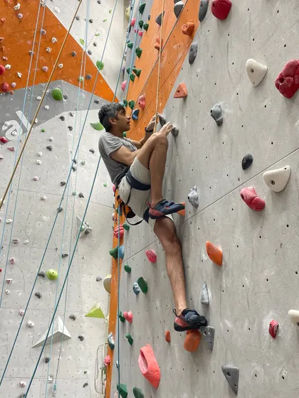 A climber focuses on a technical move, demonstrating the concentration and physical skill that the sport develops. Every route offers a new puzzle to solve.