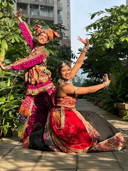 A final pose showing off the complete coordinated look. These outfits ensure you'll be one of the best-dressed couples at any Navratri event.